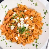 Farfalle Rustica · Blackened grilled chicken and spicy Italian sausage sautéed with mushrooms and pepperoncini ...