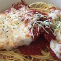 Chicken Parmigiana · Romano-crusted chicken topped with marinara and melted cheese and served over spaghetti.