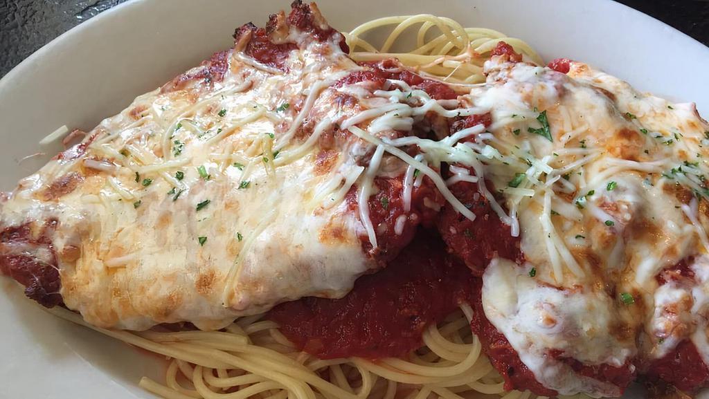 Chicken Parmigiana · Romano-crusted chicken topped with marinara and melted cheese and served over spaghetti.