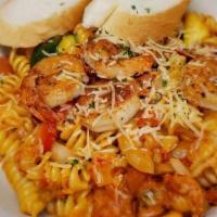 Louisiana Street Pasta · Rotini pasta topped with sautéed crawfish, sausage, zucchini, squash, red bell peppers, onio...