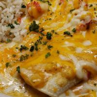 Seafood Enchilidas · Corn tortillas stuffed with seasoned shrimp and scallops, mixed with peppers, onions, and ch...