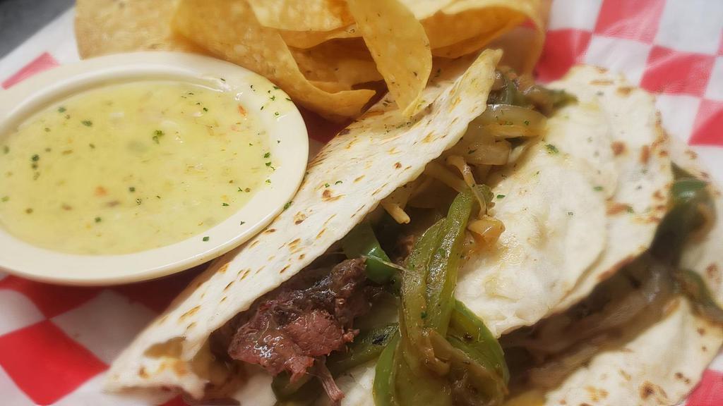 Pot Roast Tacos · Slow roasted pot roast, sauteed onions, cheddar jack cheese & cabbage with flour tortillas. Served with chips & queso.