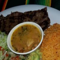 Carne Asada / Grilled Steak · Con arroz, frijoles charros, guacamole, arroz, pico de gallo y ensalada. / Served with rice,...