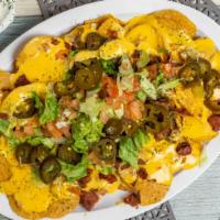 Redds Signature Nachos · Chili, cheese, grilled chicken, jalapeños, sour cream, bacon, sausage, lettuce, diced tomato...