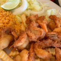 Camarones Empanizados · Ten breaded and fried jumbo shrimp, served with French fries, rice and fresh salad.