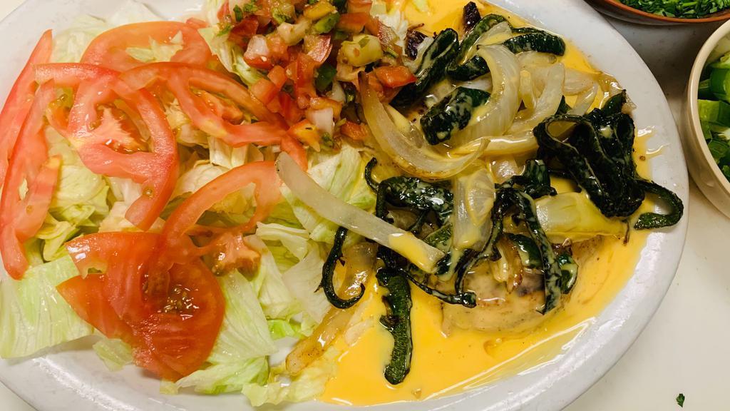 Pechuga Geo'S Style · Grilled poblano pepper and onions with cheese dip on top, served with rice, beans, pico de gallo and tortillas.
