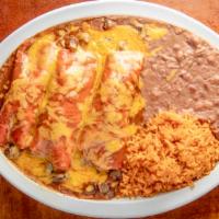Enchiladas Al Carbon (3) · Chicken or beef fajita. Topped with chile gravy and melted cheese.