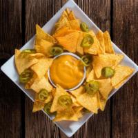 Cheese Nachos With Jalapeños · Delicious nachos, topped with melted cheese and fresh jalapeño slices.