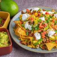 Loaded Nachos · Delicious nachos, topped with melted cheese, chili, sour cream, and fresh jalapeño slices.