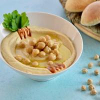 Hummus Dip · Chickpeas, lemon, garlic, tahini, salt and pepper topped with olive oil. Served with fresh p...