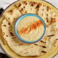 Hummus · Creamy blend of hummus. Accompanied by a pita bread. Vegetarian.