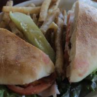 American Club · Thinly sliced smoked turkey and ham, bacon, swiss, lettuce, tomatoes and mayo on a ciabatta ...