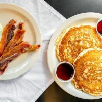 Classic Breakfast · Two farm fresh eggs, three strips of bacon and a full order of your choice of pancakes, Fren...