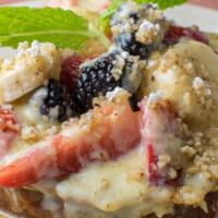 Banana Bread French Toast · Homemade banana bread dipped in cinnamon egg batter, grilled and topped with fresh berries, ...