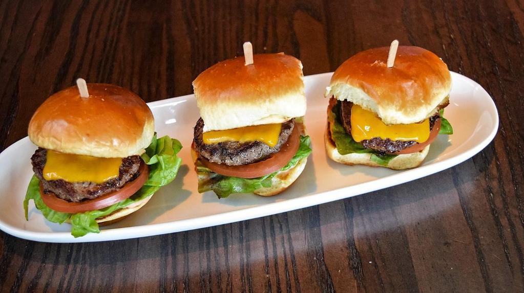 Sliders Grilled Burger · Three burger patties grilled with TL seasoning and prepared medium well. Served on toasted slider buns with melted cheddar cheese, burger sauce, red leaf lettuce, sliced tomato and pickle chips.