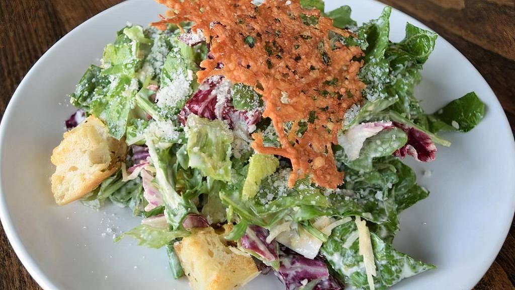 Starter Caesar Salad · Fresh crisp romaine, arugula & radicchio mixture combined with ciabatta croutons, shredded Parmesan cheese. Served with our Caesar dressing.. **Items are served raw or undercooked.  Consuming raw or undercooked eggs may increase your risk of foodborne illness*
