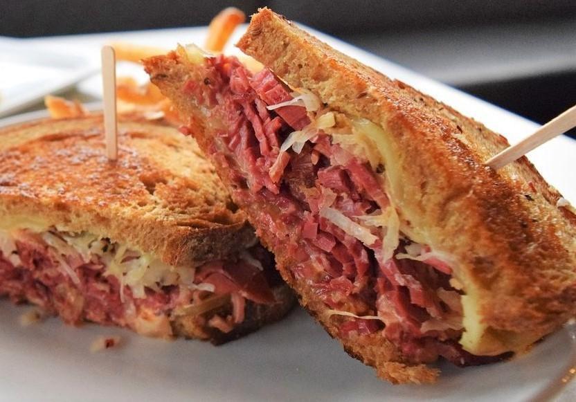 Classic Reuben · Traditional Reuben piled high with corned beef, peppered sauerkraut, melted Swiss cheese and thousand island dressing on toasted rustic rye.