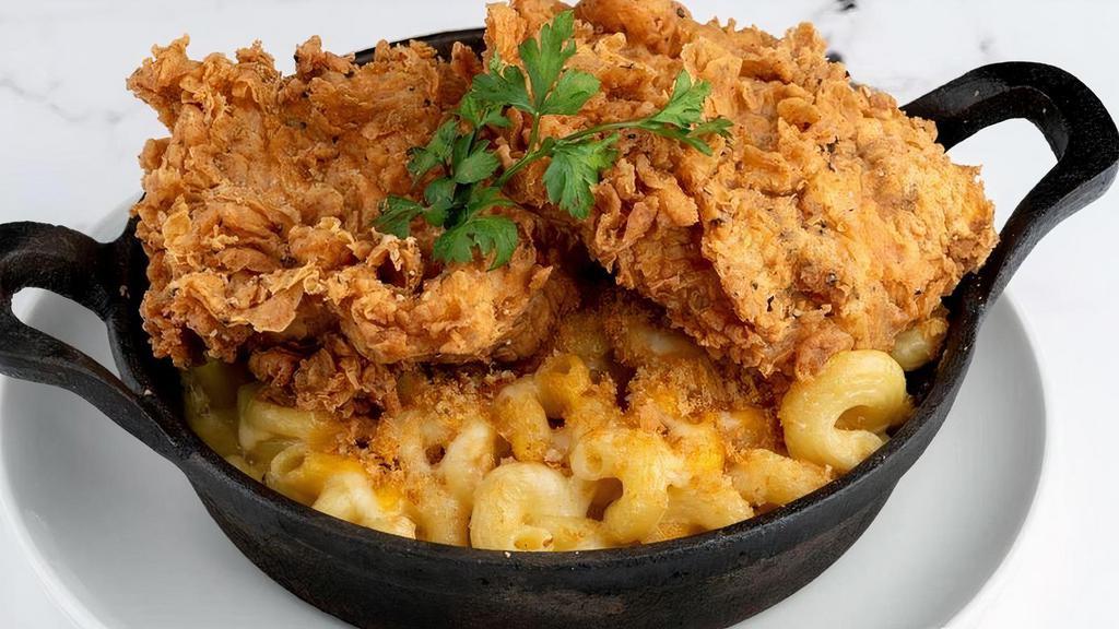 Fried Chicken Mac & Cheese · Cavatappi pasta sautéed with rich Parmesan cream sauce. Baked with cheddar, jack cheeses and breadcrumbs till golden brown. Topped with Spicy fried jalapeño buttermilk chicken.