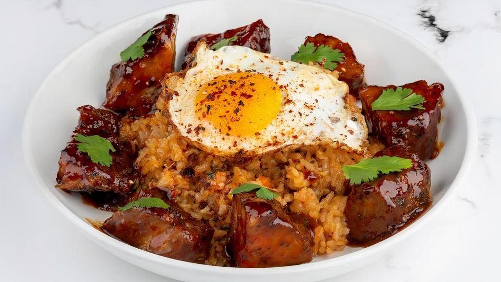 Gochuchang Korean Bbq Pork & Kimchi Fried Rice · Boneless smoked country pork ribs basted with Korean BBQ sauce and served around chopped Kimchi Fried Rice with green onions. Topped with an egg sunny side up egg.