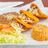 Gorditas · Three com gorditas filled with picadillo and cheese
