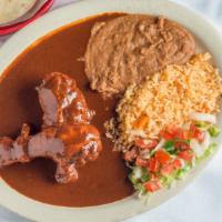 Mamas Mole · Two pieces of dark chicken with mama's authentic mole sauce.