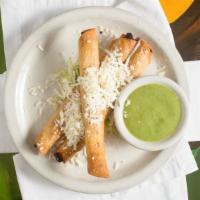 Flautas De Leah · Our award winning chicken flautas topped with Mexican cheese, served with our green salsa.