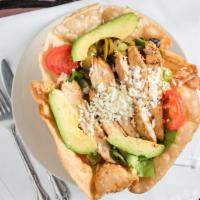 Taco Salad · Handmade flour shell filled with organic mixed greens, tomatoes, onions, jalapeños avocado, ...