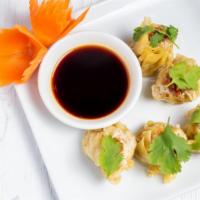 Thai Dumpling · Steamed rice tart filled with stuffed chicken served with sweet brown sauce (5).
