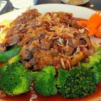 Crispy Duck · Deep fried duck breast served over steamed vegetables and triple flavor sauce.