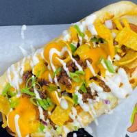Frito Pie Dog · Fritos, beef chili, Cheddar cheese sauce, sour cream and scallions.