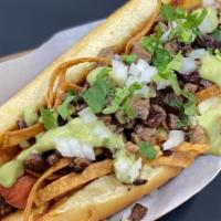 Taquero Vaquero Dog · Carne Asada, guacamole salsa, tortilla strips, onions, cilantro