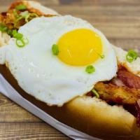 The Egg Dog · Fried egg, bacon chips, crispy potato, spicy ketchup.