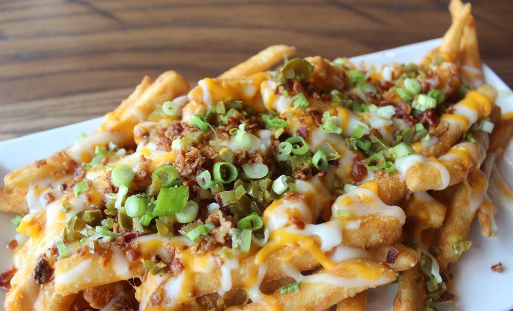 Loaded Fries · topped with cheddar jack cheese, bacon, jalapeño, green onions served with house-made ranch