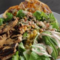 The Southwestern Salad · green leaf lettuce, grilled chicken breast,  pico de gallo, cheddar jack, roasted corn, driz...