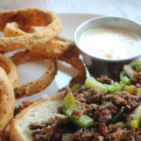 The Texas Philly Cheesesteak · sliced sirloin with sautéed onion, bell pepper, jalapeños, and served with a side of queso o...