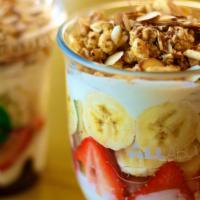Yogurt Parfait · Greek yogurt combined with blueberries, strawberries, bananas, granola, and toasted almonds.