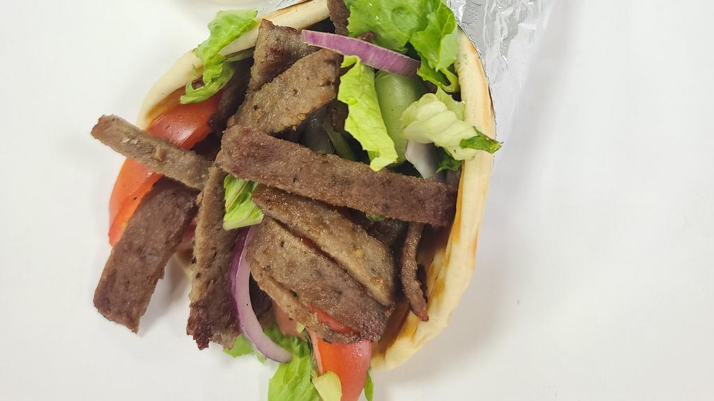 Gyro Sandwich · Beef gyro on pita bread with lettuce, tomatoes, onions , cucumbers and sauces