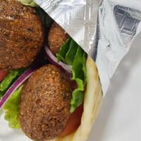 Falafel Sandwich · 100% vegetarian. falafel on pita bread with lettuce tomatoes onions cucumber and sauces