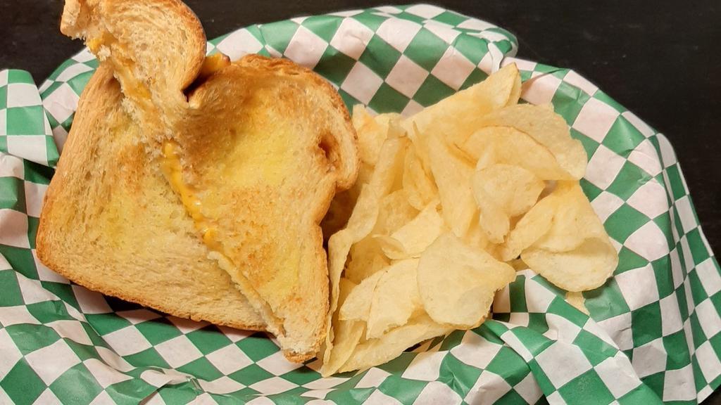 Mexican Style Grilled Cheese · Buttered, House Cheddar cheese sauce and sliced cheese + chips on the side.