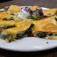 Mi Tierra Quesadillas · Spinach, mushrooms, grilled onions, and poblano peppers with guacamole and sour cream. Optio...