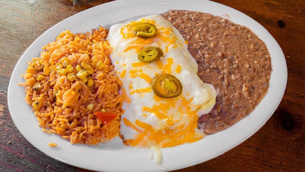 Tex-Queso Enchiladas · Enchiladas covered with chili con queso filled with your choice of jack and cheddar cheese or picadillo served with Mexican rice and refried beans