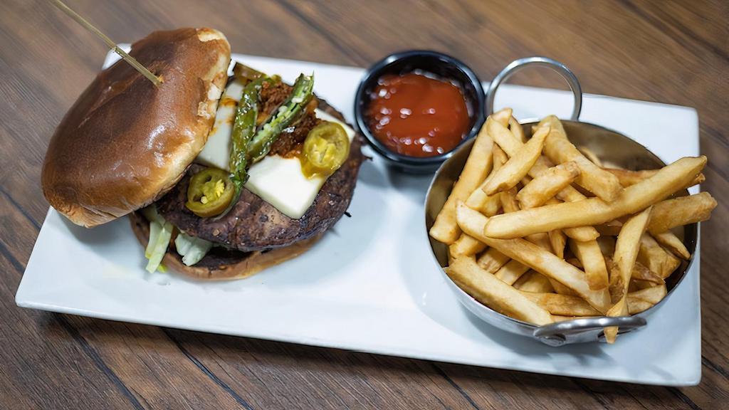The Mexican Hamburger · Our Cheese Hamburger with Chorizo, Guacamole, Queso Fresco, and Roasted Peppers. Served with Fries.