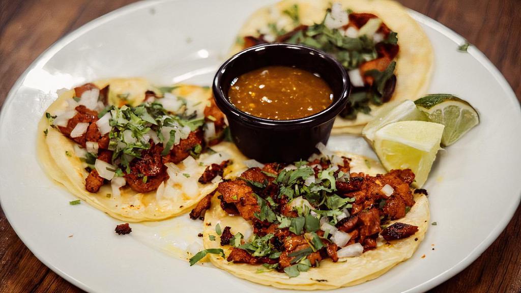 Tacos De La Calle · Served with cilantro and onions and our house made taco sauce. Your choice of Asada, Al Pastor, Pollo Parrilla, or Chorizo.