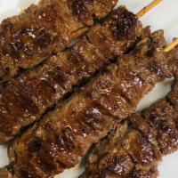 Beef Skewers (4 Pieces) · Grilled beef marinated in Thai style sauce on bamboo skewers. Served with Thai sweet and sou...