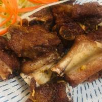 Fried Pork Ribs  · Deep fried cut pork ribs marinated in Thai style and top with fried garlic. Served with Thai...