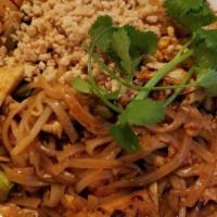 Famous Pad Thai · Rice noodles stir-fried with eggs, tofu, bean sprouts, green onions, and ground peanuts on t...