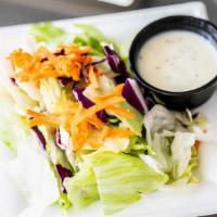 Side Salad · A simple house salad with Iceberg Lettuce, Cabbage, and Carrots served with the house Lemon ...