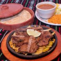 Fajitas Enchiladas · Two beef or chicken enchiladas covered with gravy topped with cheese. Served with rice and r...