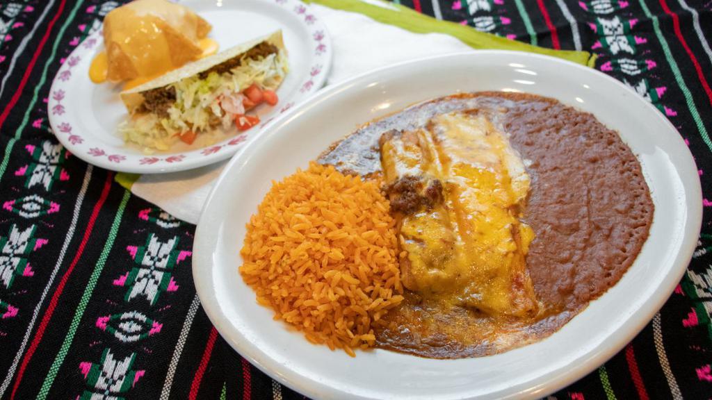 Deluxe Dinner · Crispy ground beef taco, chile con queso puff, one cheese enchilada, one tamale, covered with gravy, and topped with cheese. Served with rice and refried beans.