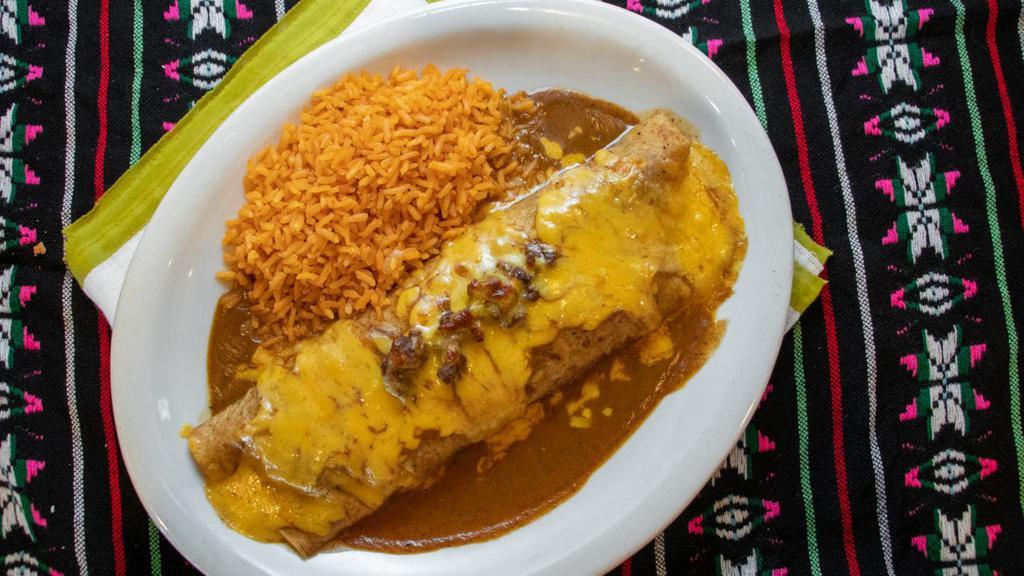 Fajitas Burrito · Large flour tortilla filled with beef fajita and refried beans, covered with gravy and cheese. Served with rice.